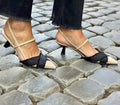 Women's apricot and black colour-block stiletto heel sandals with pointed toe and ankle buckle.