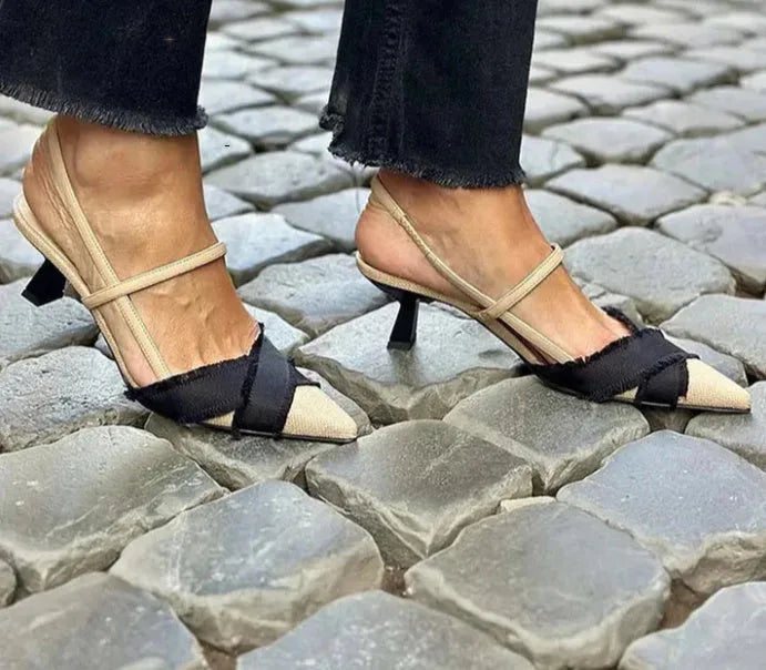 Women's apricot and black colour-block stiletto heel sandals with pointed toe and ankle buckle.