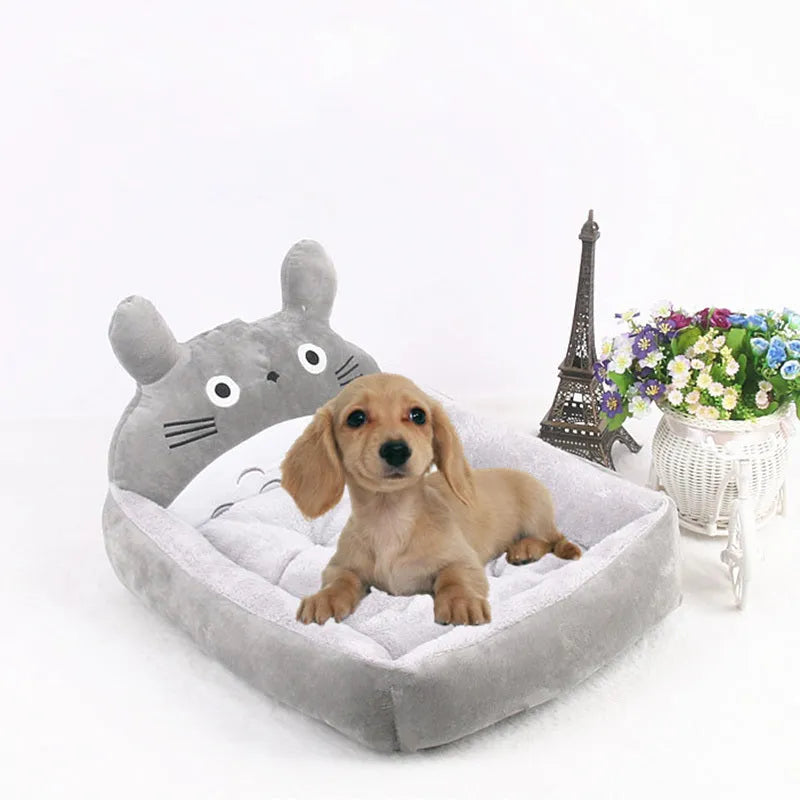 A colourful cartoon-style sofa bed for small pets, shown in blue, with raised edges for comfort.