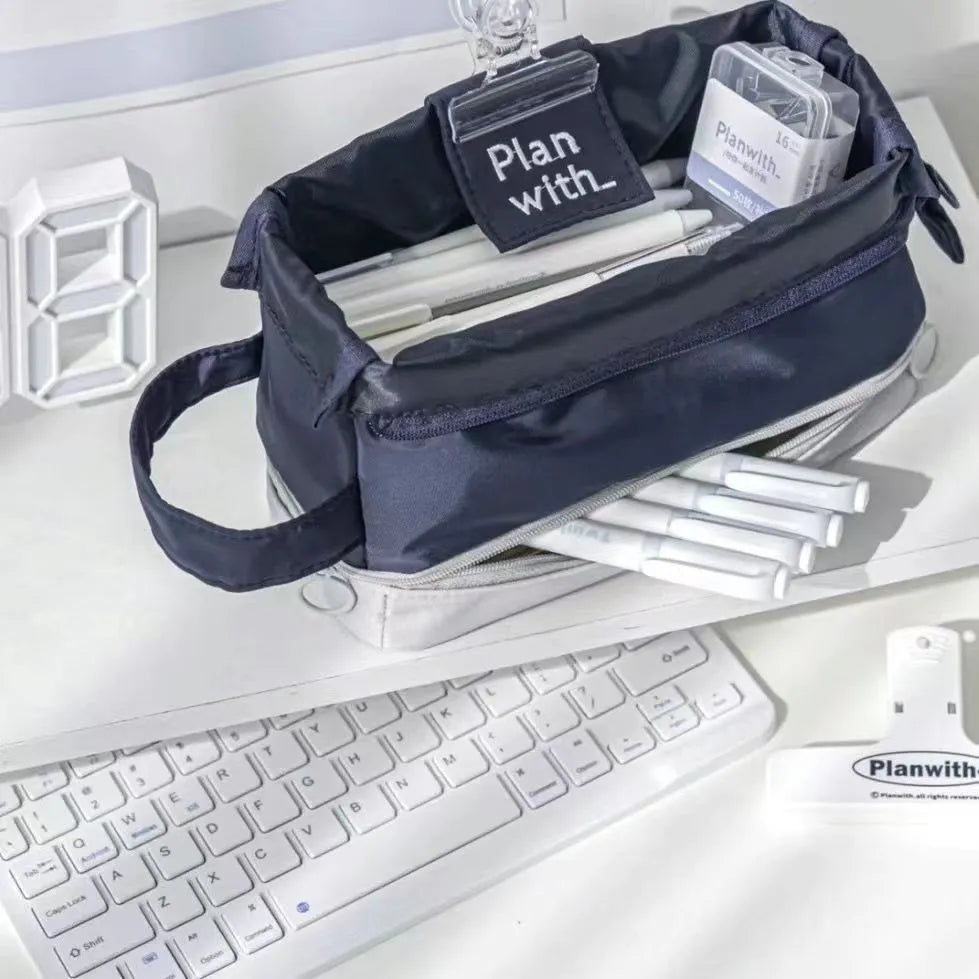 Dark blue folding double layer pencil case with internal compartments open to show organisation