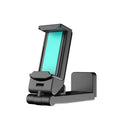 Black foldable rotating phone holder holding a mobile phone on a desk.