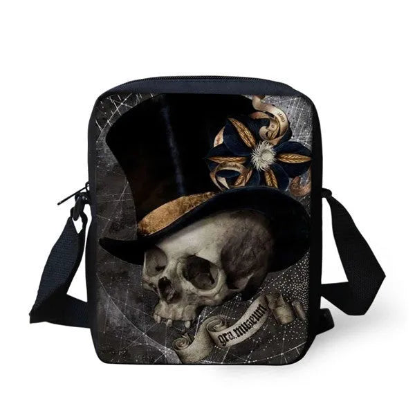A medium-sized black children's messenger bag with a white skull graphic, showing the double straps and front zipper pocket.