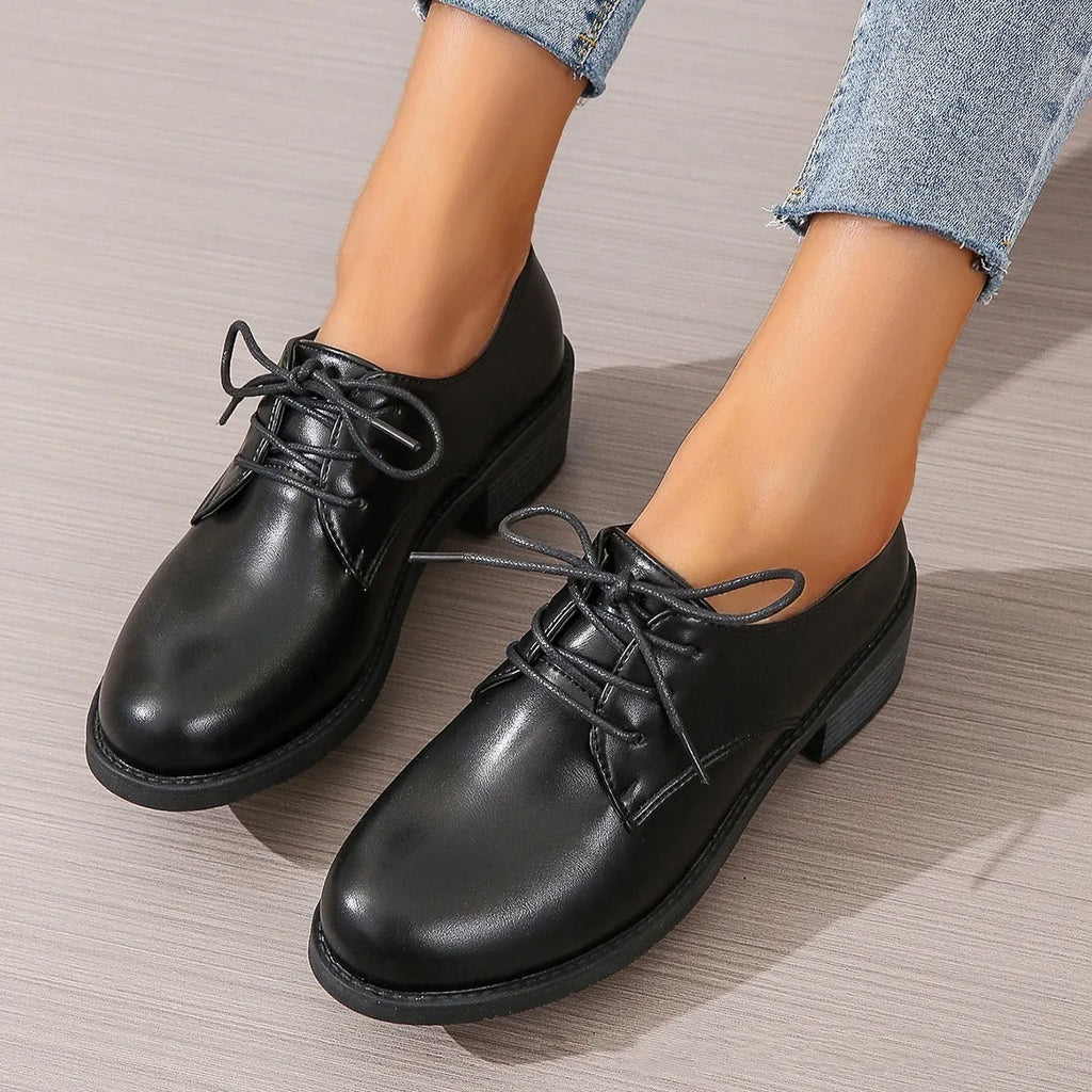 Black women's low-top work shoes with a thick chunky heel and rounded toe.