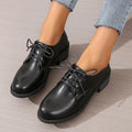 Black women's low-top work shoes with a thick chunky heel and rounded toe.