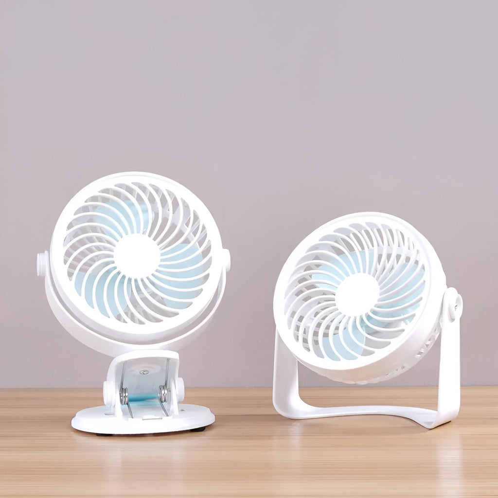 Small white USB desktop fan with clip attached to a desk edge, showing three blades.