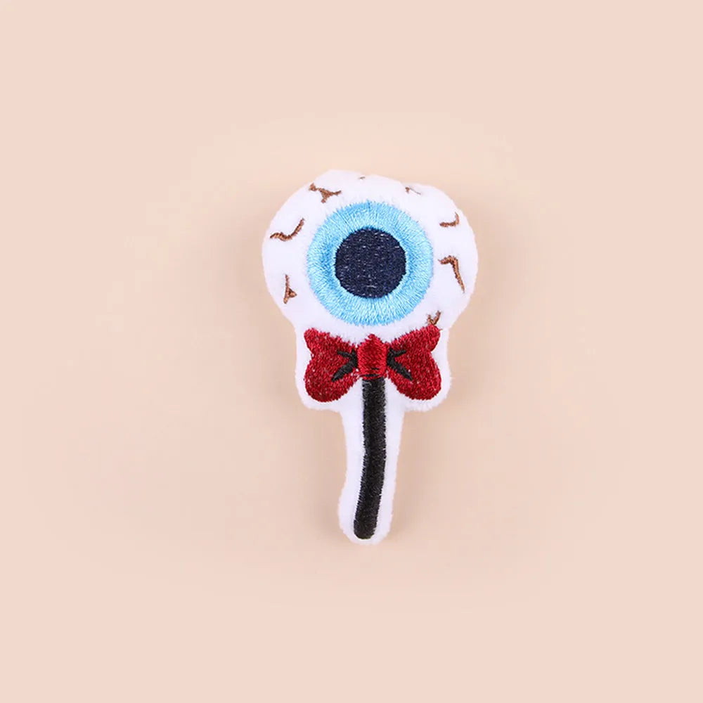 Small plush cat teaser toy with flexible handle in candy, eyes, or skull design