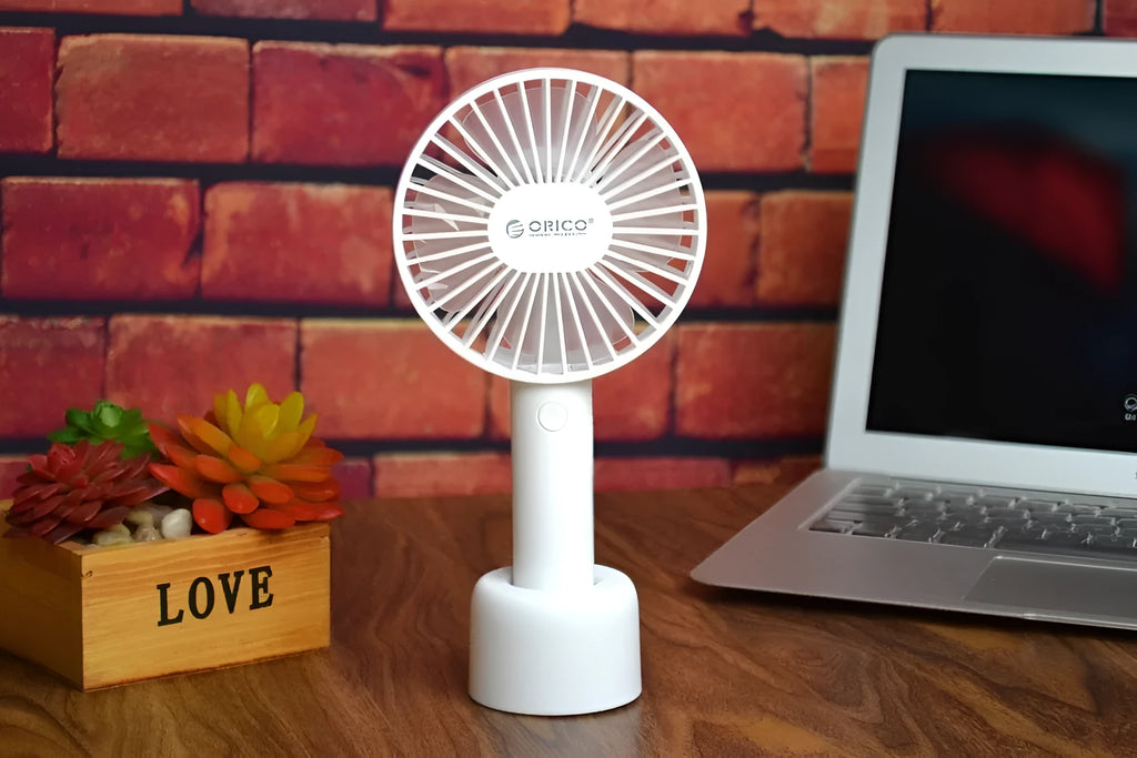 White ORICO FH1 portable USB rechargeable desk fan showing three-speed buttons and compact design