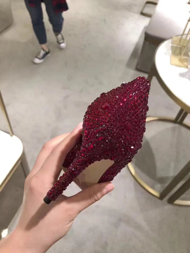 Women's gold pointed toe high heels with rhinestone details and stiletto heel