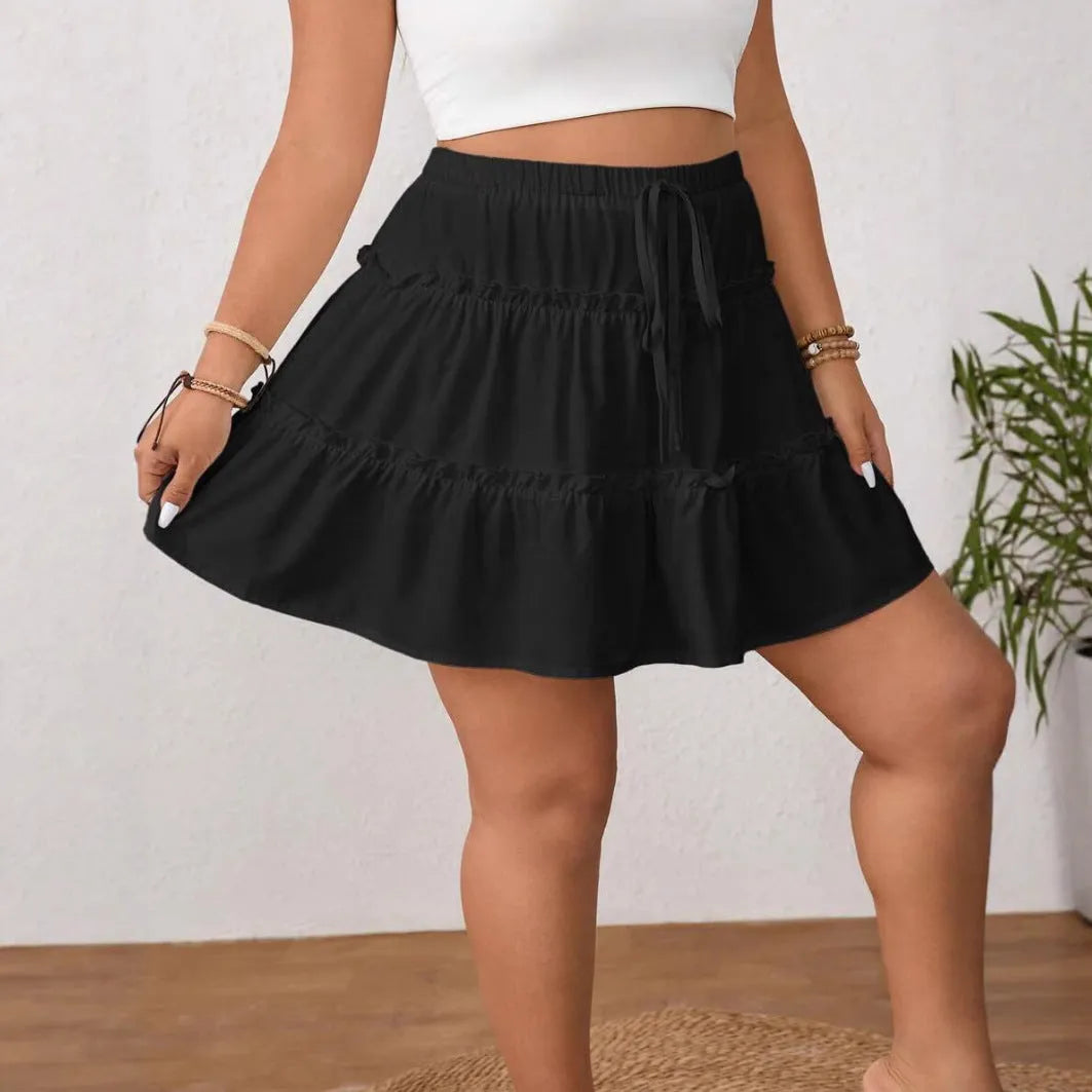 White pleated A-line short skirt with an adjustable lace-up waist detail on a mannequin.