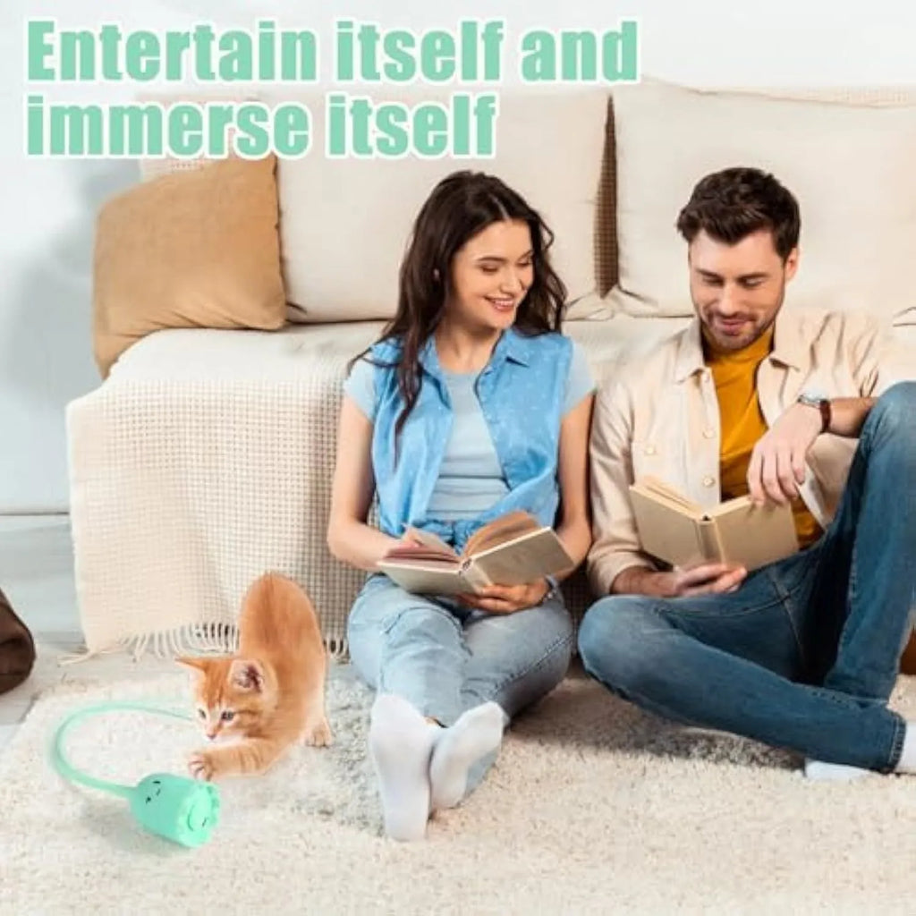 Green automatic electronic cat wand toy with swinging silicone tails on a table.
