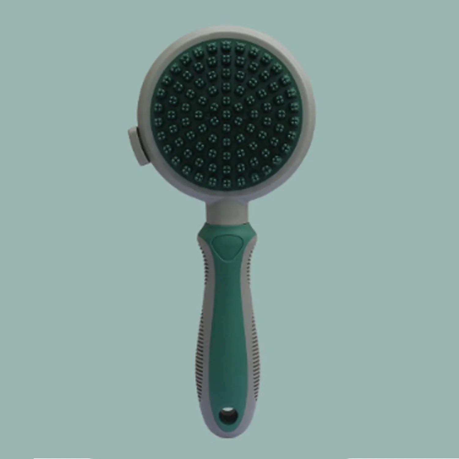 Pink and green double-sided cat grooming brush with a release button and a separate flea comb.