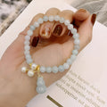 Emerald green jade bracelet with Chinese gourd design elements