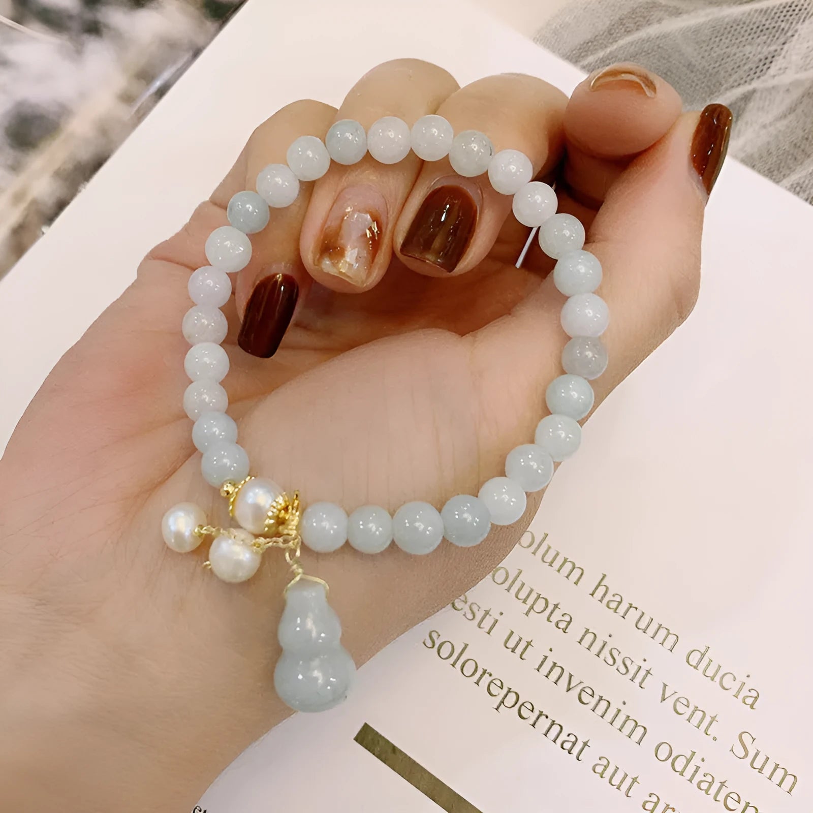 Emerald green jade bracelet with Chinese gourd design elements