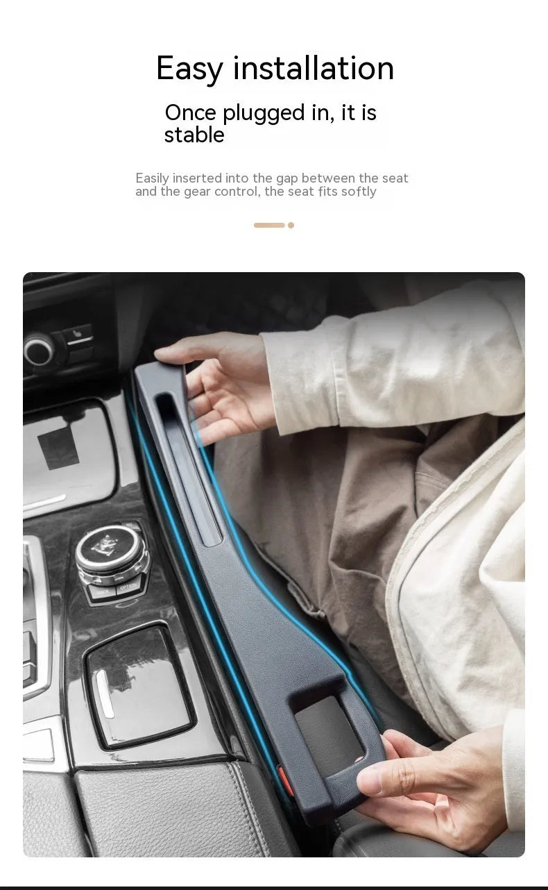 Black plastic car seat gap storage box with removal handle inserted between vehicle seats