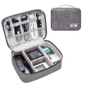 Black waterproof electronics organiser case open, showing mesh pockets, elastic loops, and removable padded dividers inside.