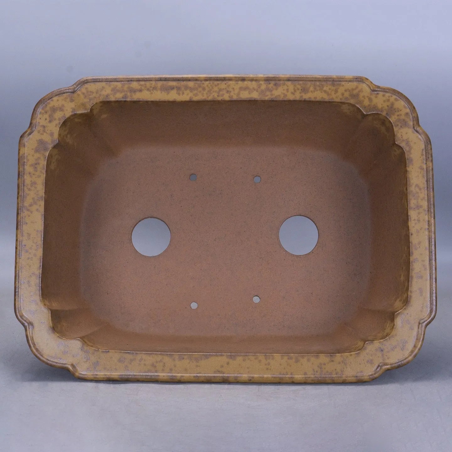 Purple sand rectangular flowerpot showing textured segment mud construction and geometric angles.