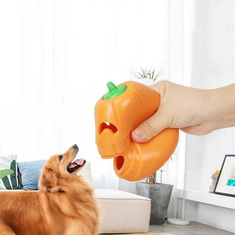 Orange Halloween pumpkin shaped dog chew toy with treat-dispensing funnel opening