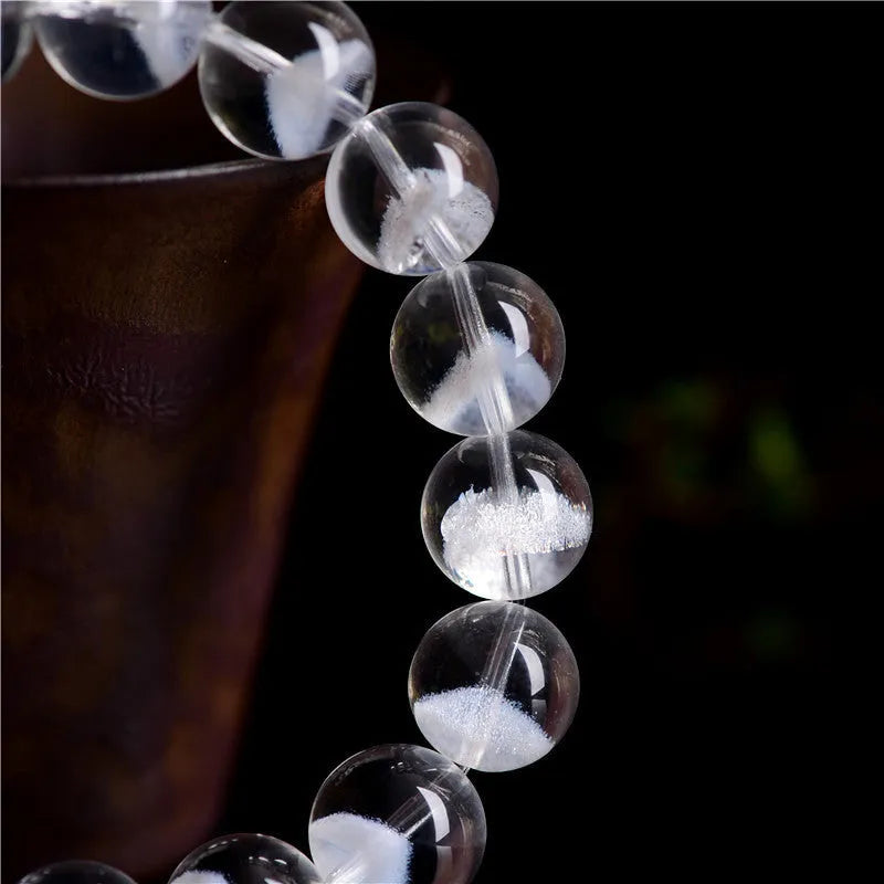 Women's white crystal pyramid bead bracelet with Ruyi element on wrist