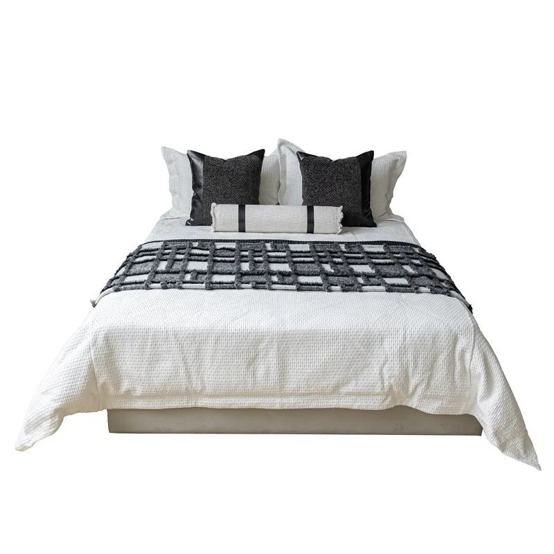 Modern minimalist grey and white plaid bed runner set with leather round pillow on a 1.5m-1.8m bed