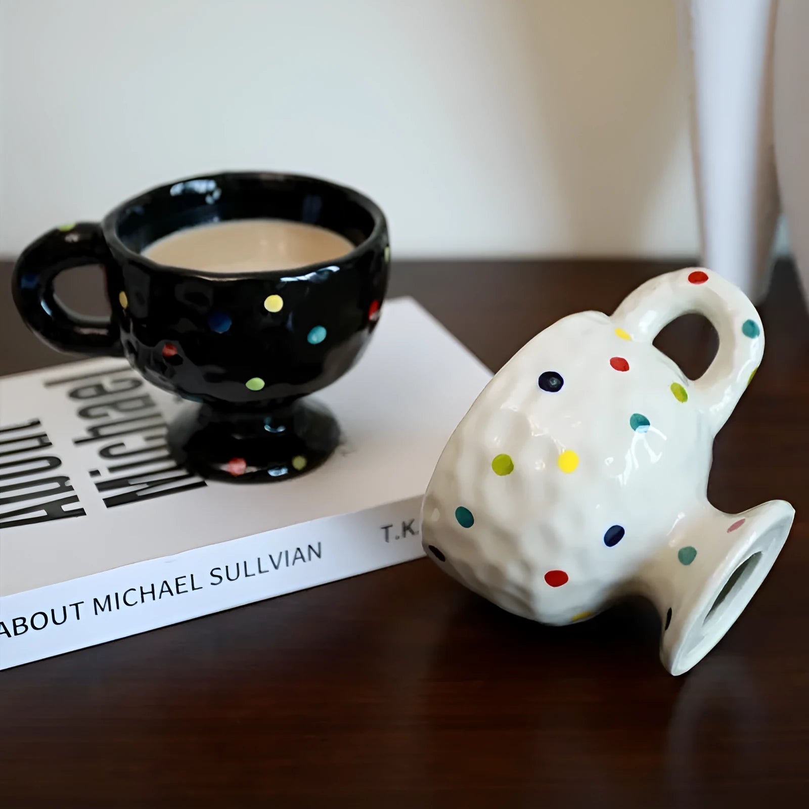 A handmade, irregularly shaped ceramic mug in a solid colour, shown on a table.