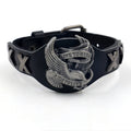 Black geometric leather bracelet with Eagle watch-button detail, showing tapered width.