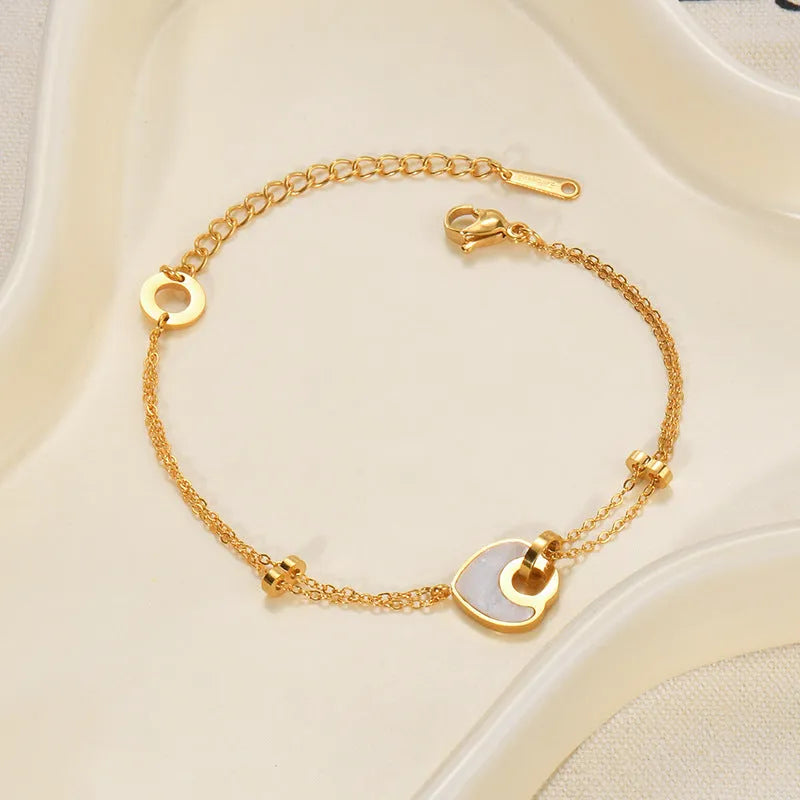 Stainless steel and resin bracelet for women with a double-layered heart-shaped charm.