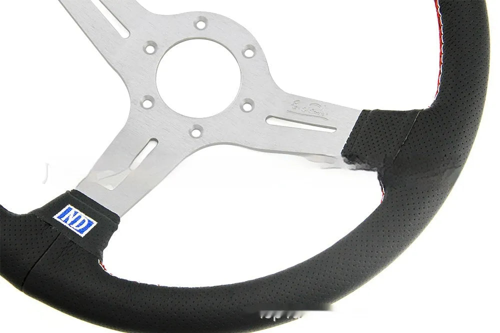 14-inch black leather steering wheel with concave design and silver metal skeleton.