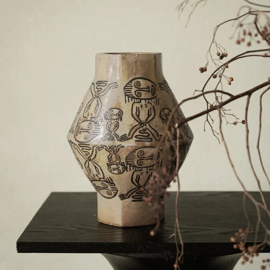 Ceramic vase with hand-painted vintage carved tribal totem art in religious symbolic patterns