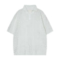 Men's black short-sleeved polo shirt with loose fit and cardigan style on hanger