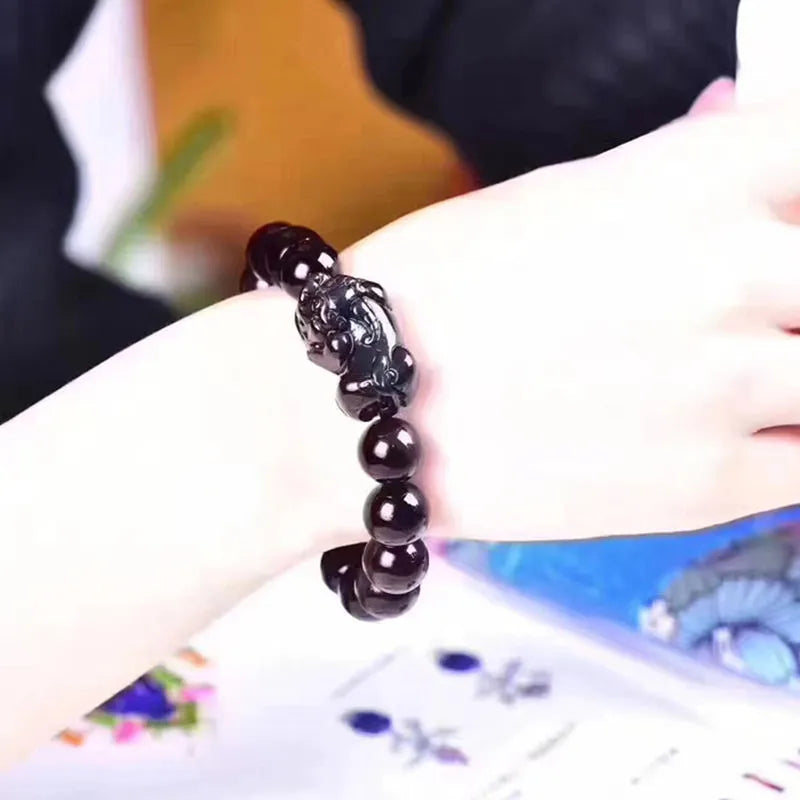 Natural ice colour obsidian crystal bracelet with spherical beads on wrist