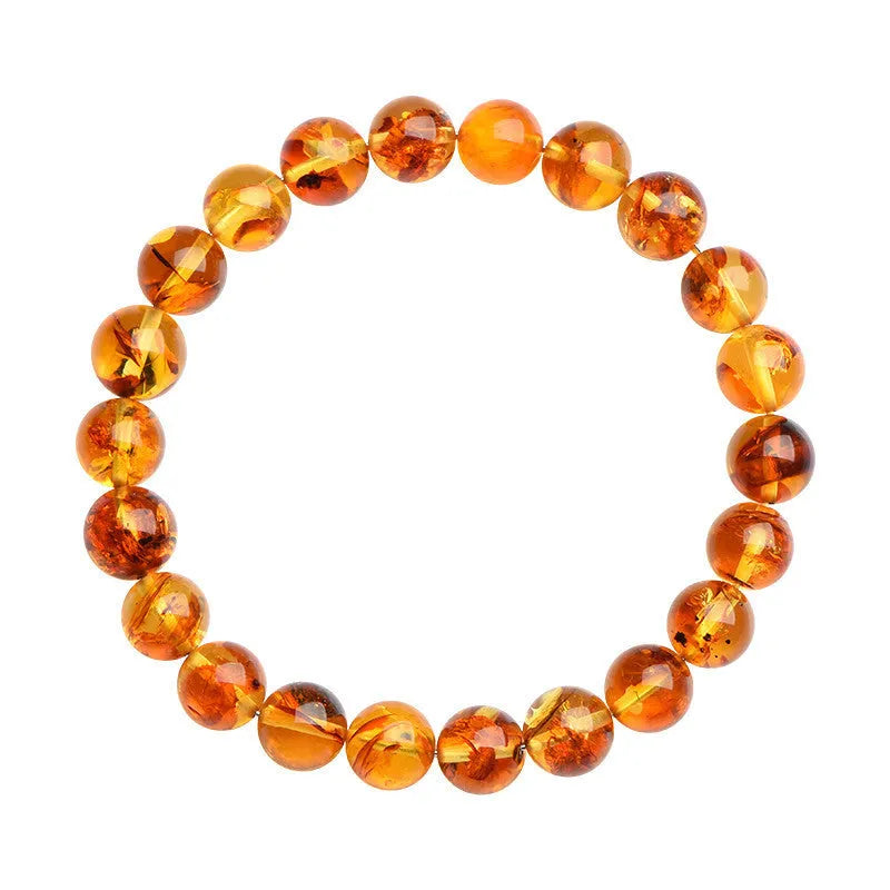 Natural yellow piebald amber bracelet with geometric beads on a white background.