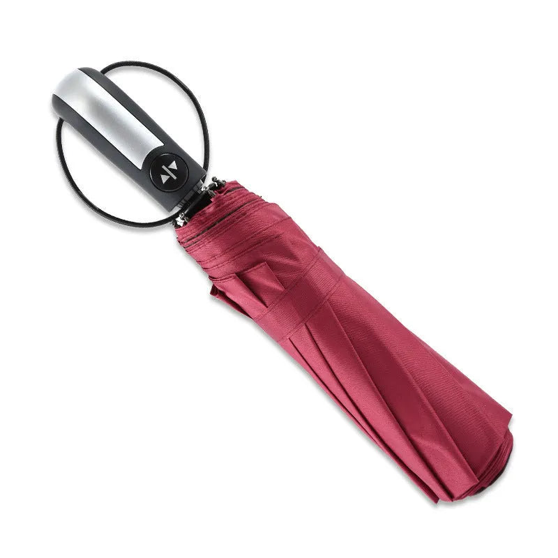 Automatic triple folding black business sun shade umbrella with steel ribs and a rubber handle.