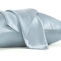 Solid colour mulberry silk envelope pillowcase in dark grey on a bed