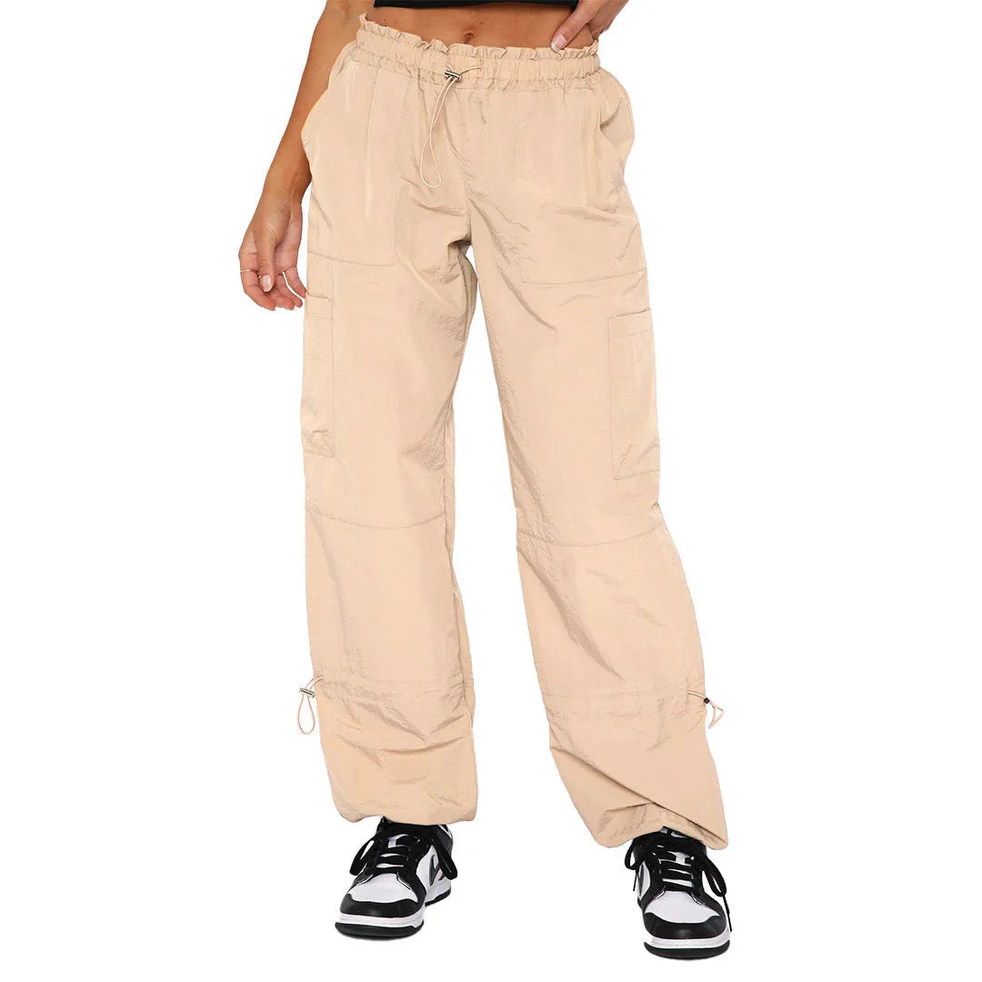 Loose-fit straight-leg cargo casual trousers in grey on a model, showing multiple pockets and mid-rise waist.
