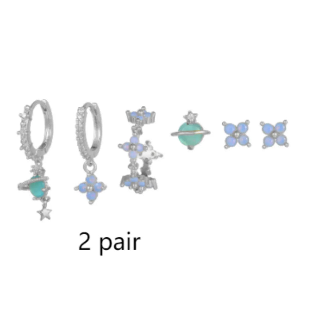 Gold and silver floral stud earrings with blue protein flower nail and zircon mosaic detail.