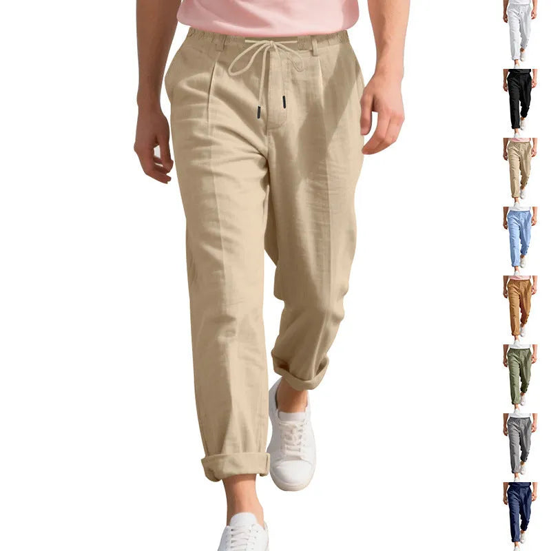 Men's light khaki linen casual trousers with drawstring waist and straight loose leg on hanger.