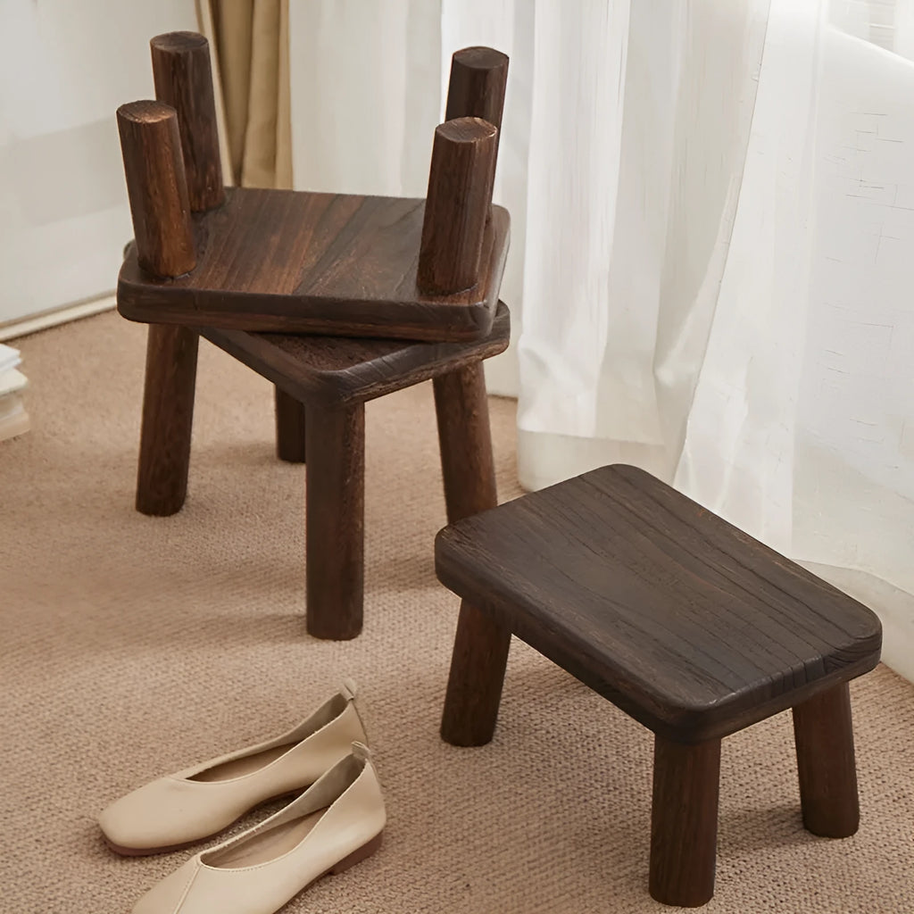 Solid wood household changing stool with a distressed finish for shoes in a living room.