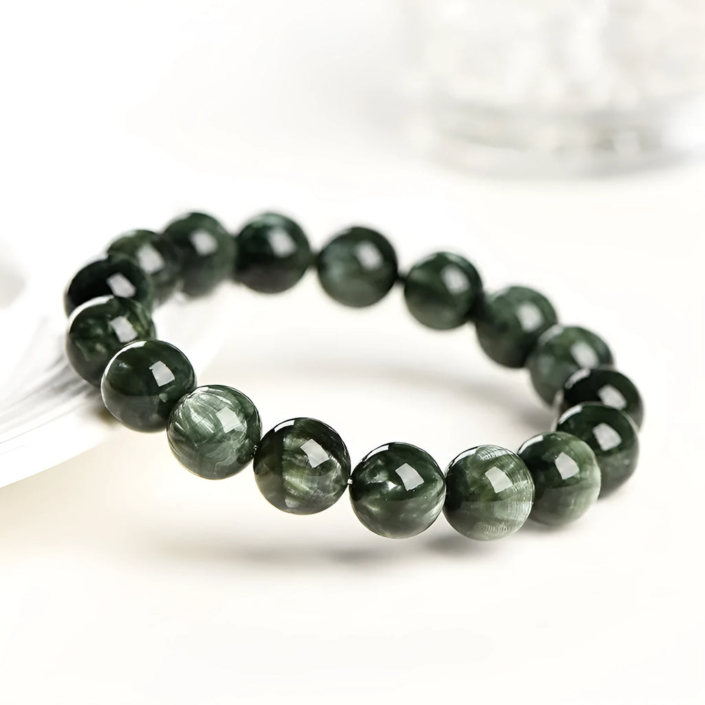 A single-ring green dragon crystal bracelet with round beads and a ruyi design element.