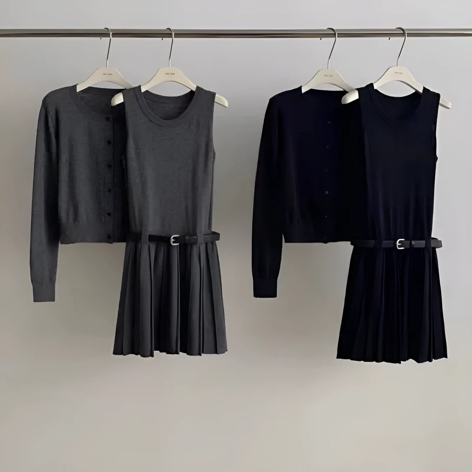 Women's grey Art Retro knitted vest skirt and long-sleeved cardigan two-piece set with pleated detail.