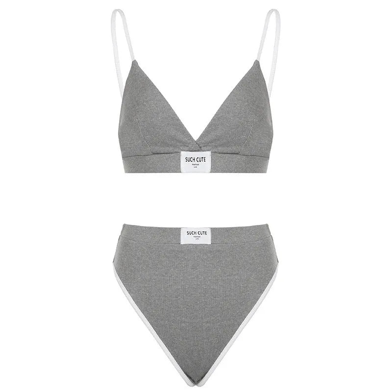 Women's grey bikini set with decorative embroidery and white contrast colour binding on the sleeveless top and shorts.