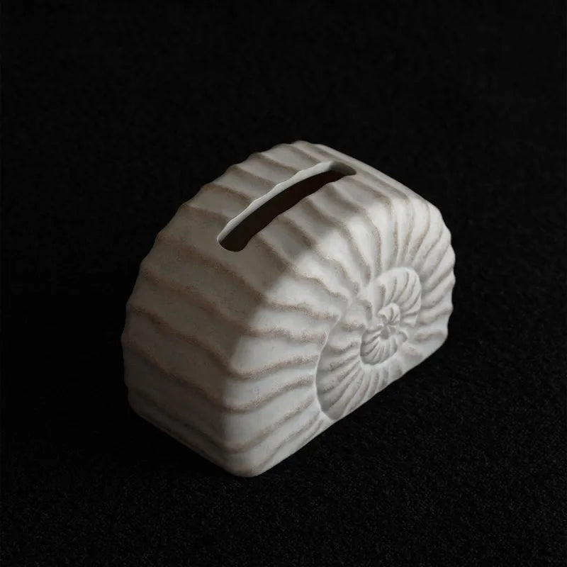Modern simple resin tissue box cover with decorative conch ramble pattern.