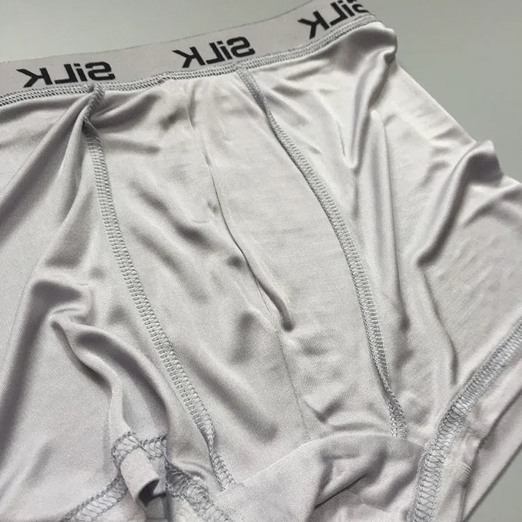 Men's casual silk shorts in navy blue, shown with a loose fit and mid waist design