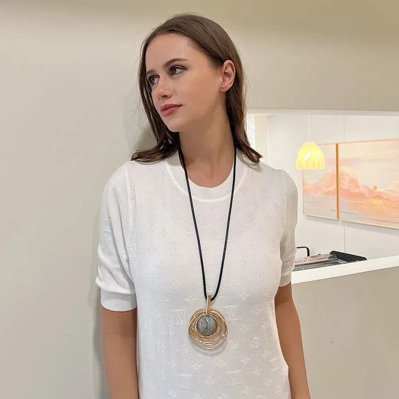 Vintage women's geometric sweater chain necklace with gold alloy pendant and snakeskin wax rope chain.