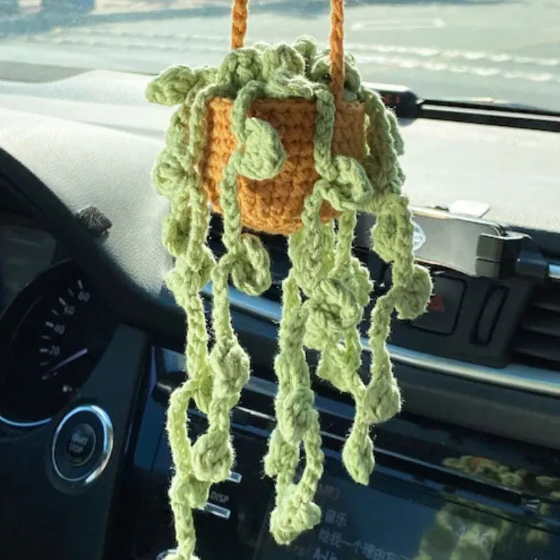 Knitted green and white car plant decoration with hanging rope