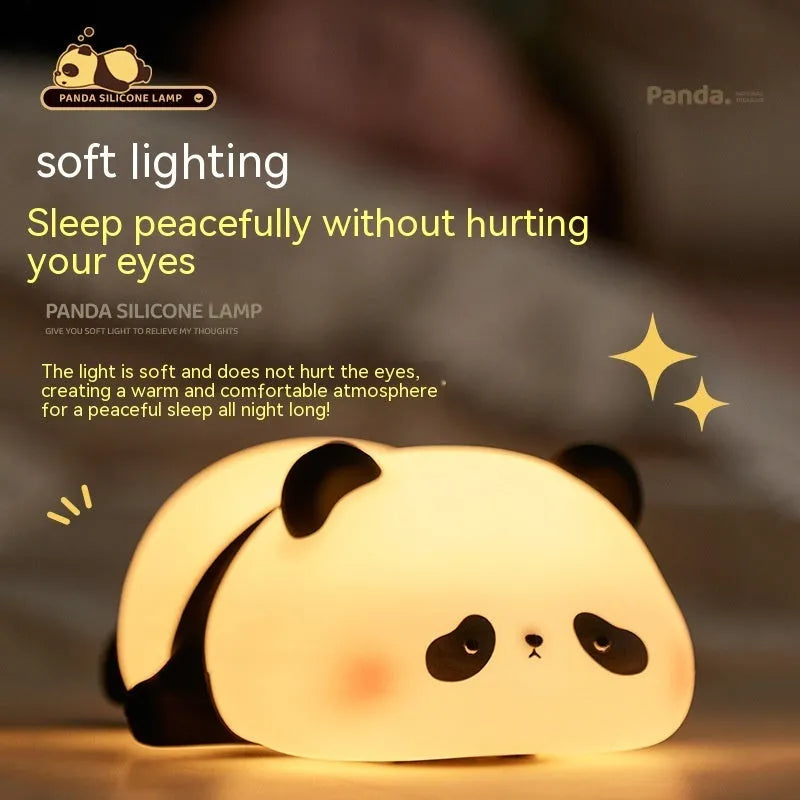 Cartoon panda-shaped silicone night light for kids on a bedside table.