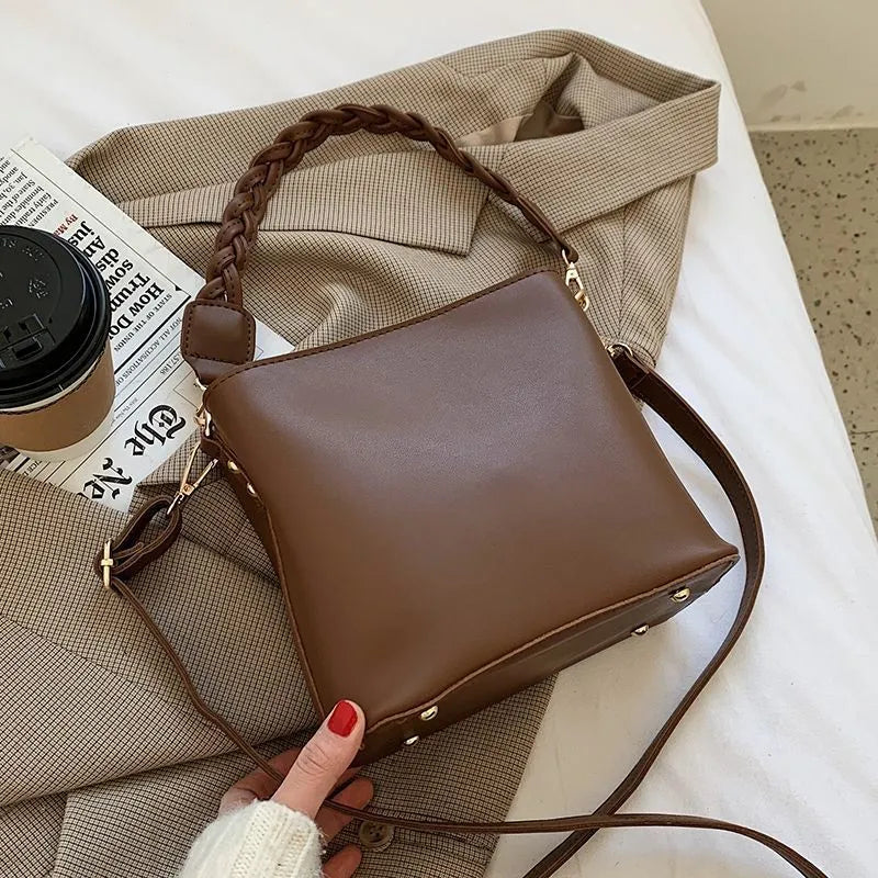 Retro-style khaki PU underarm bucket bag with a woven pattern and a crossbody strap.