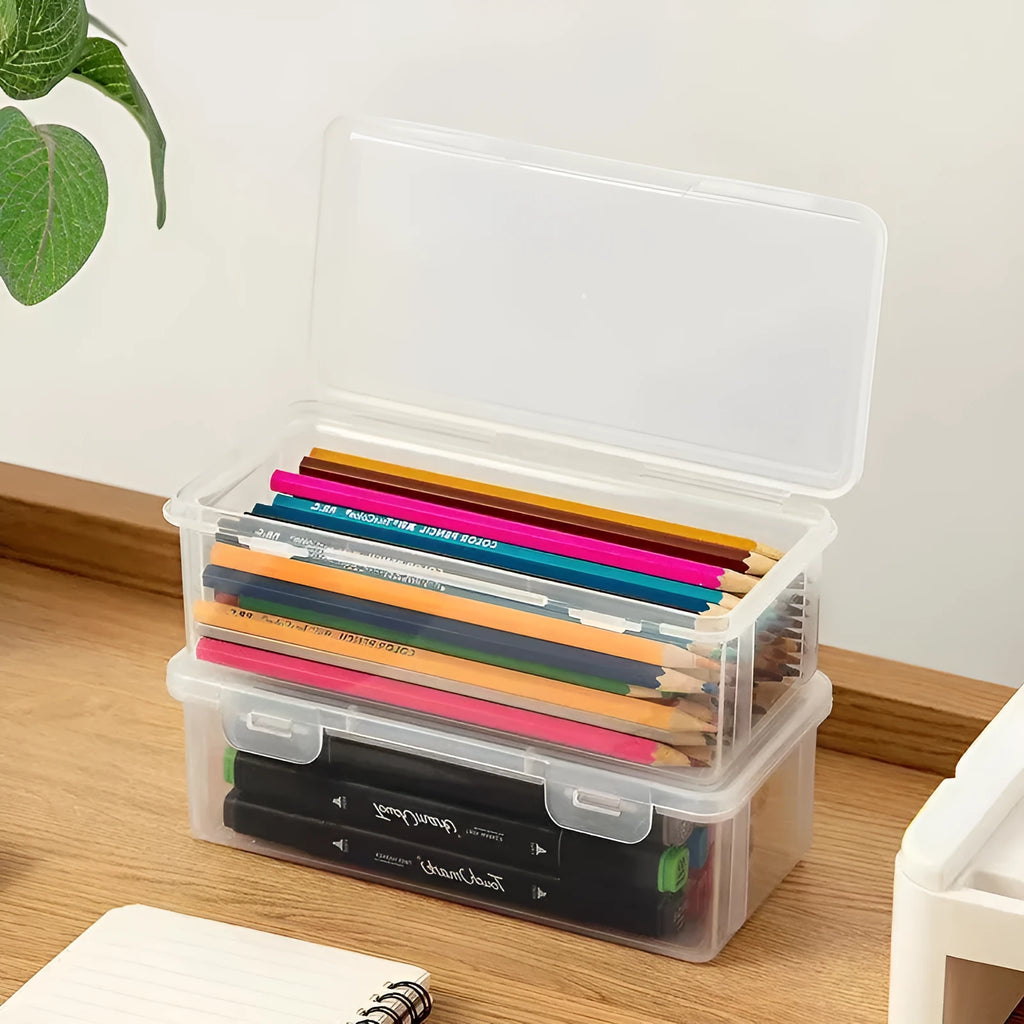 Transparent plastic stationery storage box containing pencils and coloured art supplies