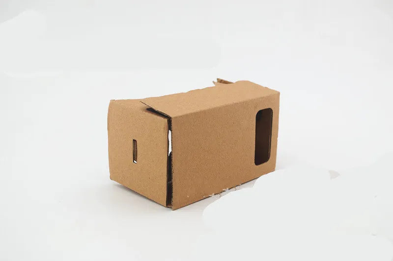 Flat-pack DIY VR cardboard glasses kit for 6-inch smartphones with 3D lenses, rubber band, and velcro strap.