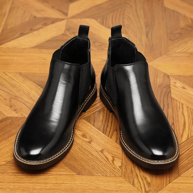 Men's black formal pointed-toe leather boots with a square rubber heel on a plain background