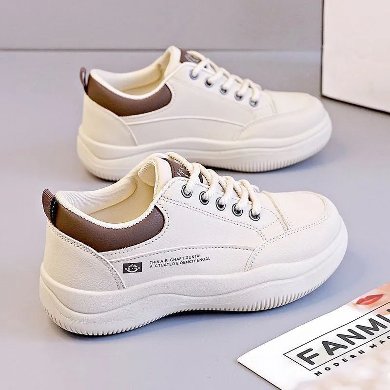 Women's white Korean-style casual shoes with cross strap detail and a synthetic leather upper.